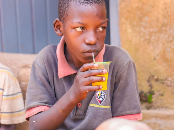 A boy drinking juice at the outreach