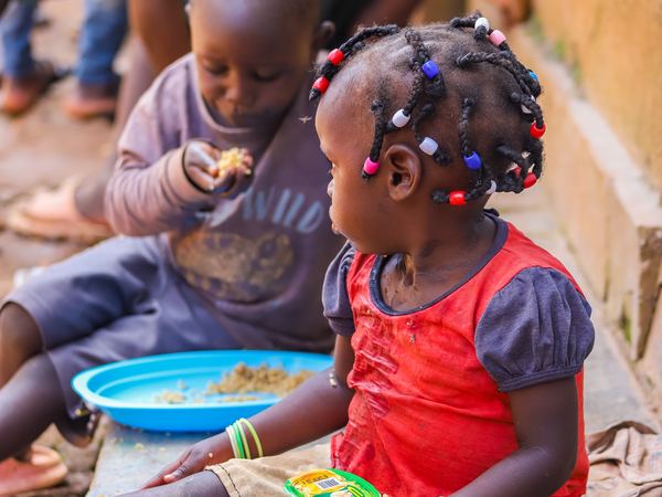 Two young children eating together