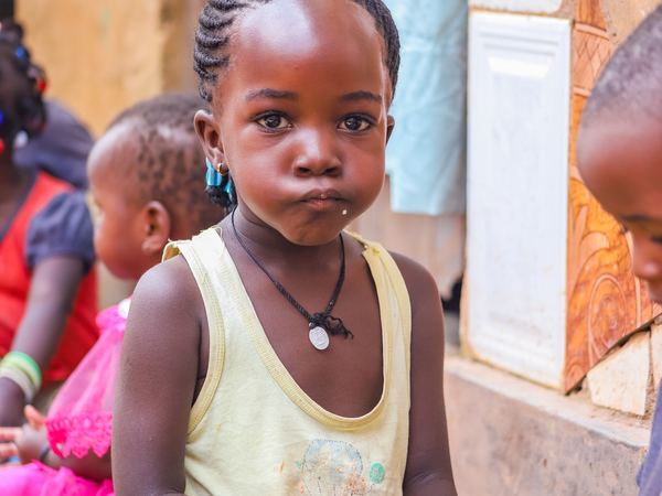 A little girl in a yellow top at the outreach