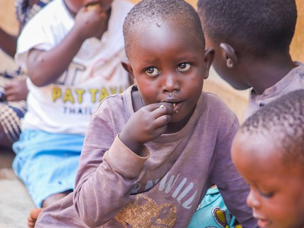 A boy eating with his friends