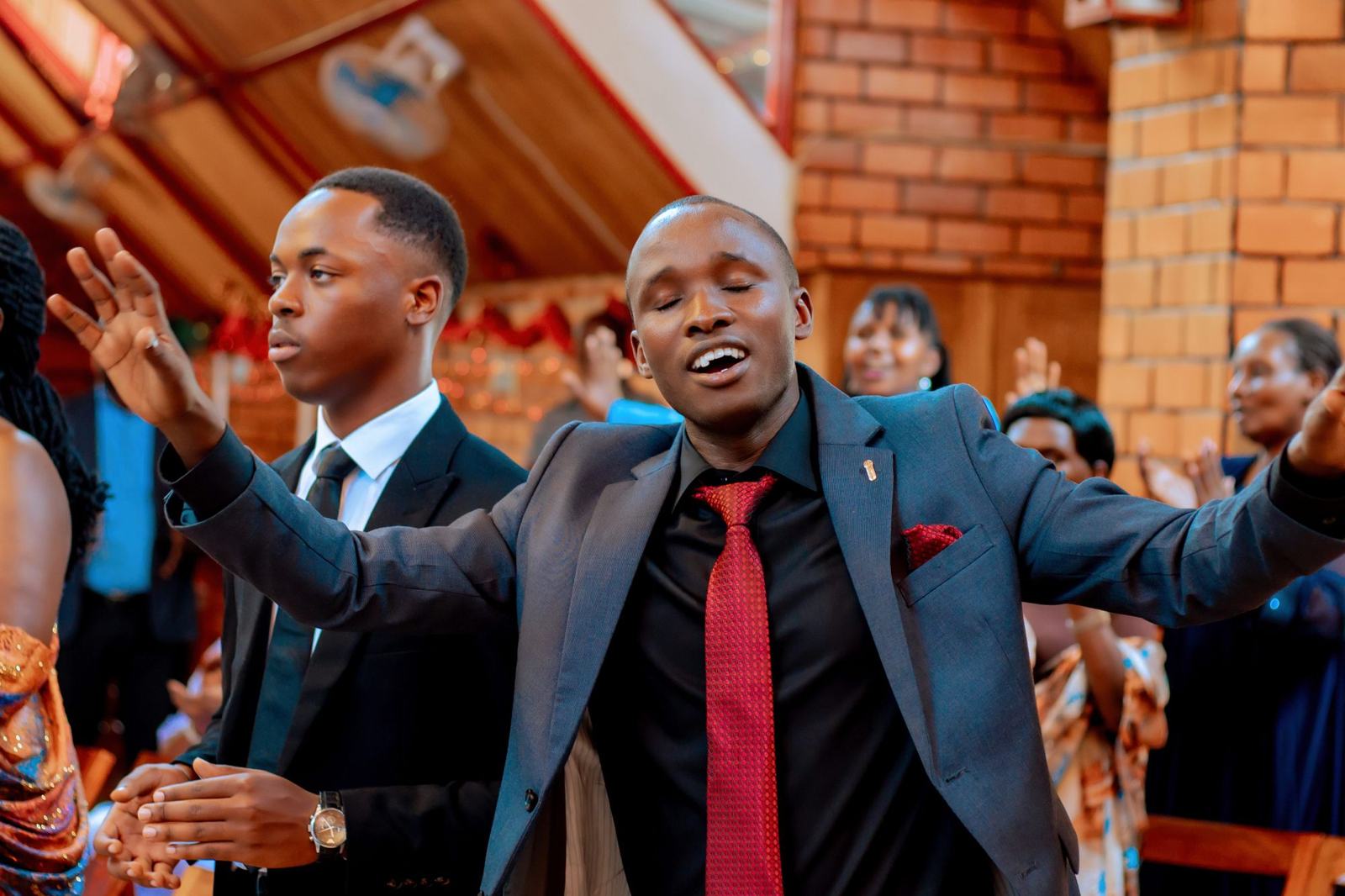 Young men worshipping joyfully during a church service