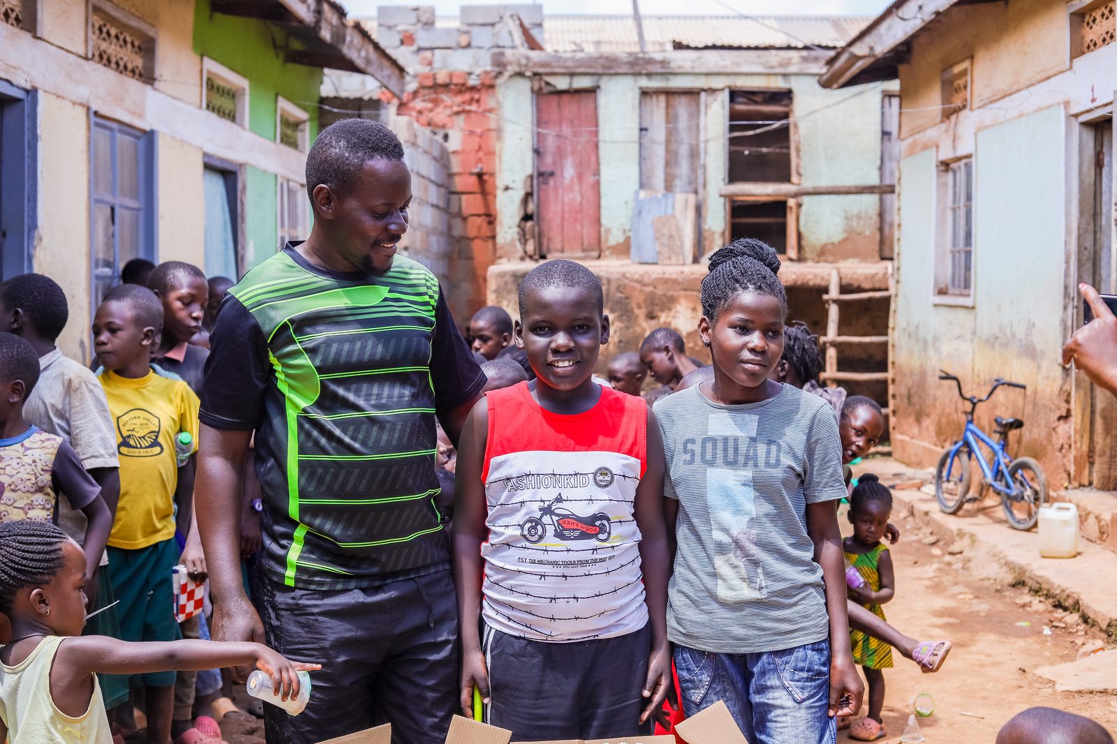 Our team member standing with children in their community